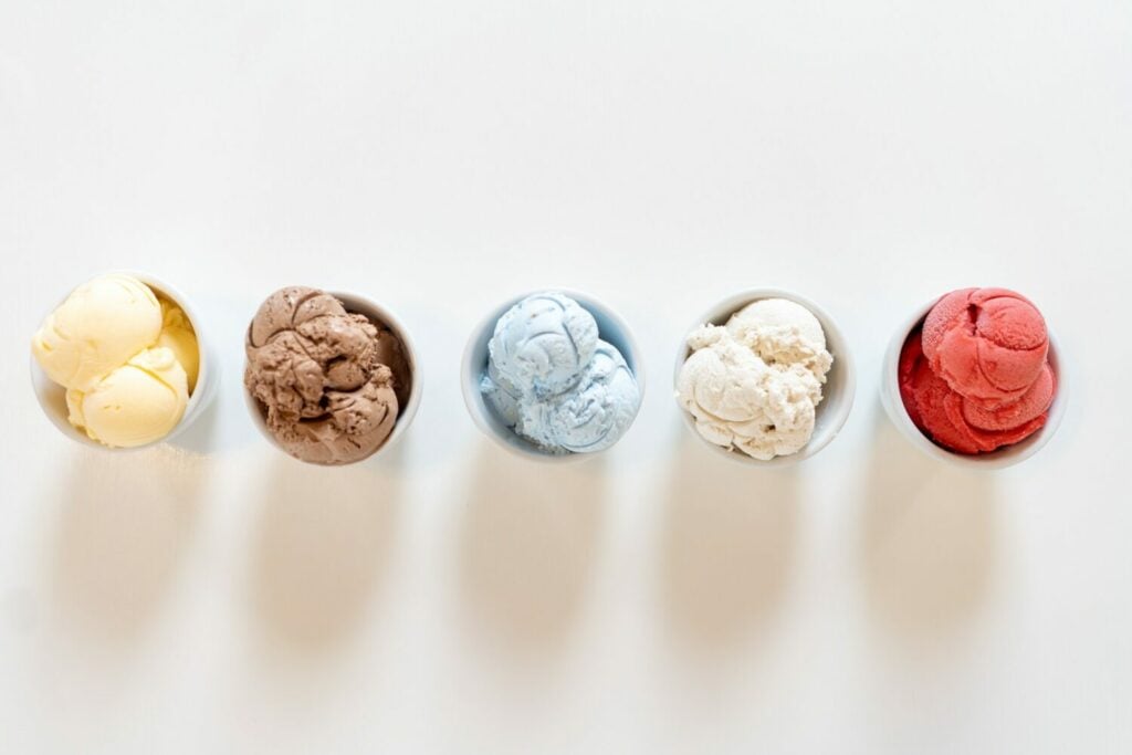 Aerial view of different cups of colorful ice cream