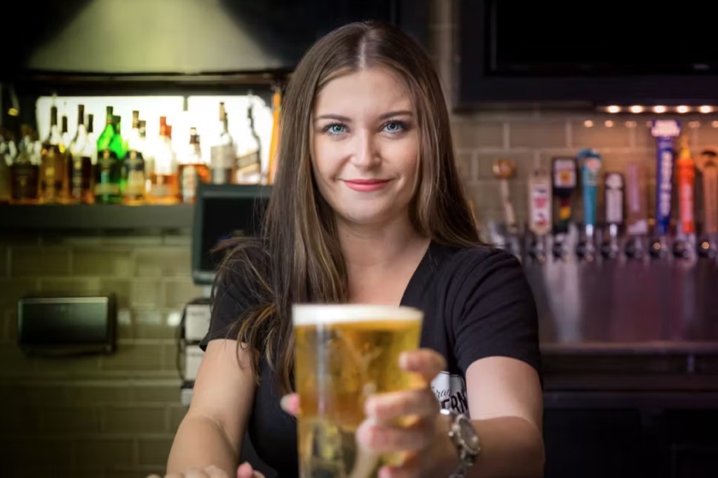 Bartender serving happy hour beer at Torrance Tavern