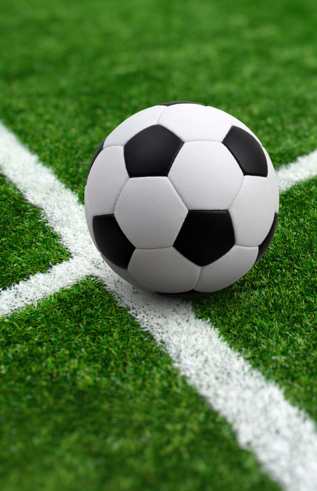Soccer ball sitting on the stadium field