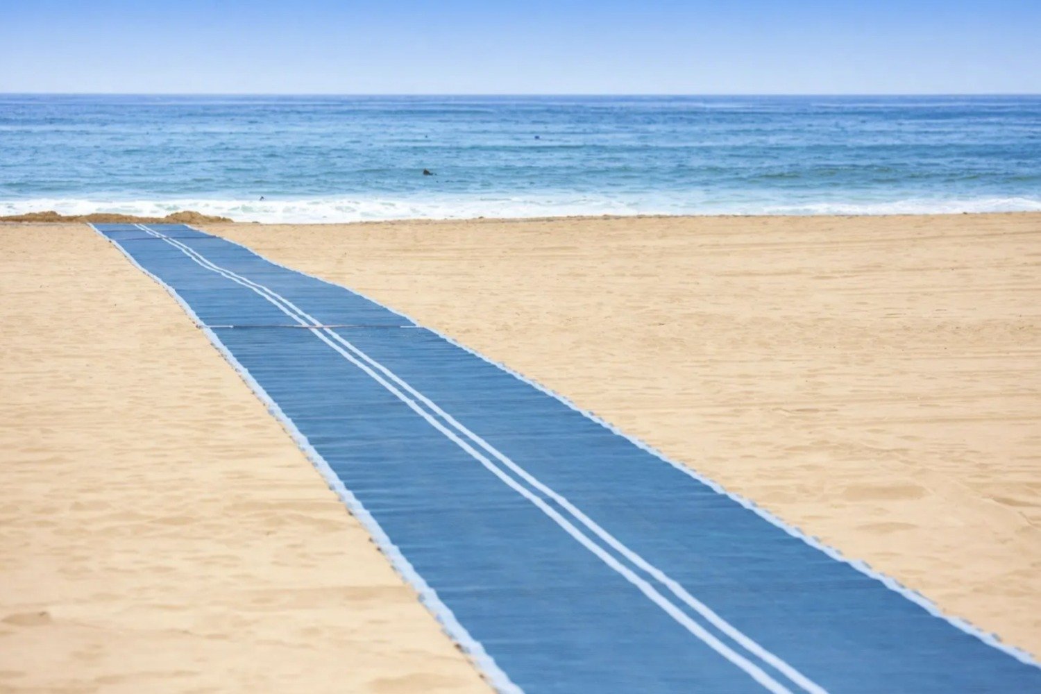Wheelchair accessible rug that allows people to go further into the beach and closer to the ocean