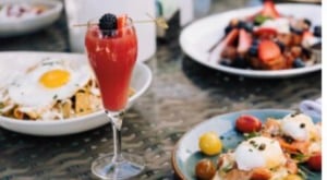 Brunch table with various plates and a fruity beverage
