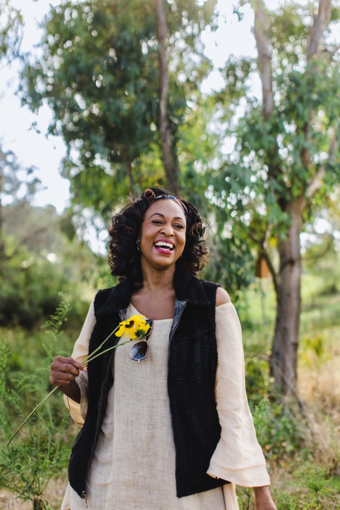 Woman holding flower exploring Madrona Marsh Preserve and Nature Center