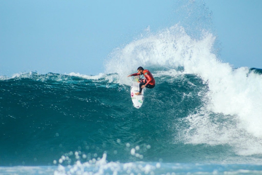 Surfer riding a cresting wave