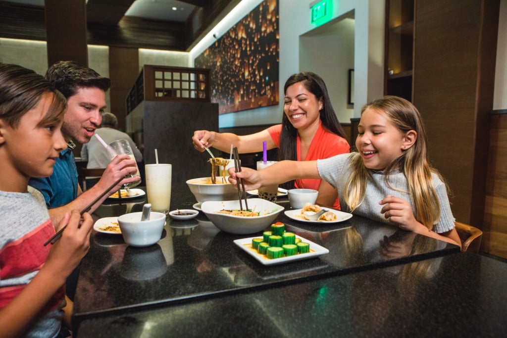 Family with kids eating at restaurant in Torrance, CA